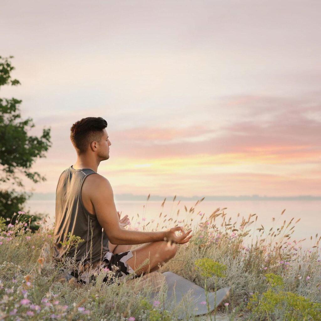 A man sitting meditating.